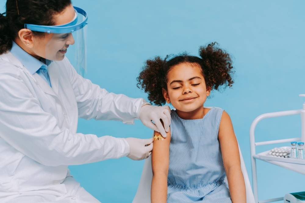 Little girl gets school vaccines